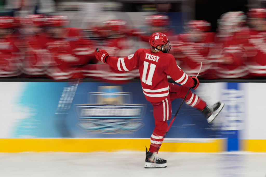 Wisconsin forward Simon Tassy (11) celebrates after scoring against North Dakota in the first period of a semifinal game of the NCAA Frozen Four men's college hockey tournament Thursday, April 9, 2026, in Las Vegas. (AP Photo/John Locher)