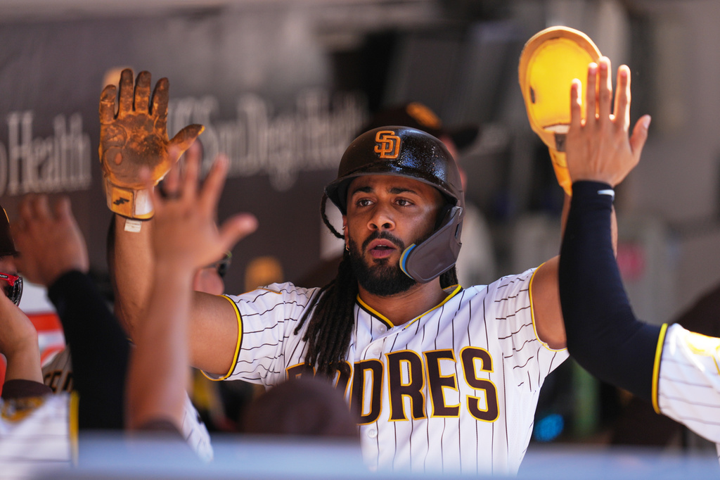 San Diego Padres' Fernando Tatis Jr. celebrates after scoring off an RBI single by Jake Cronenworth during the eighth inning of a baseball game against the Milwaukee Brewers Wednesday, Aug. 12, 2026, in San Diego. (AP Photo/Gregory Bull)