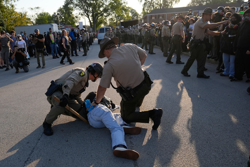 Law enforcement detains a protester near an Immigration and Customs Enforcement facility in Broadview, Ill., Friday, Oct. 3, 2025. (AP Photo/Erin Hooley) Law enforcement detains a protester near an Immigration and Customs Enforcement facility in Broadview, Ill., Friday, Oct. 3, 2025. (AP Photo/Erin Hooley)