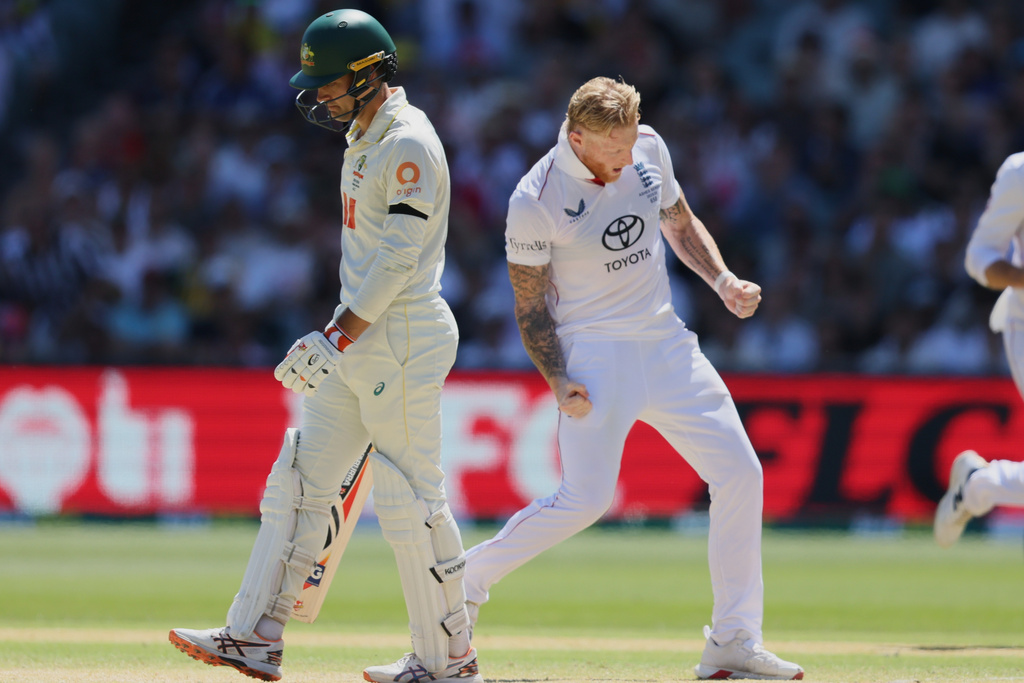 England's Ben Stokes, right, celebrates after dismissing Australia's Alex Carey, left, during play on day four of the third Ashes cricket test between England and Australia in Adelaide, Australia, Saturday, Dec. 20, 2025. (AP Photo/James Elsby)