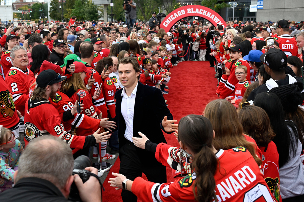 Chicago Blackhawks center Connor Bedard greets fans on a red carpet before an NHL hockey game against the Montreal Canadiens, Saturday, Oct. 11, 2025, in Chicago. (AP Photo/Matt Marton)
