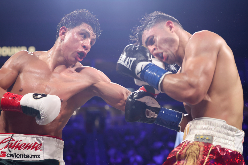Jaime Munguia punches Armando Resendiz in a super middleweight championship boxing match Saturday, May 2, 2026, in Las Vegas. (AP Photo/Ian Maule)