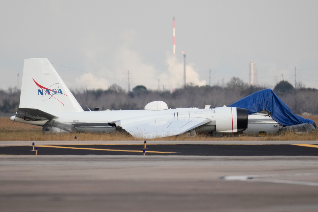A NASA aircraft sits near a runway at Ellington Airport after making a belly landing on Tuesday, Jan. 27, 2026, in Houston. (AP Photo/Ashley Landis)