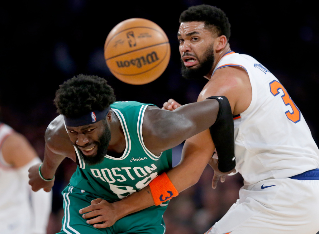 Boston Celtics center Neemias Queta, left, and New York Knicks center Karl-Anthony Towns battle for a loose ball during the first half of an NBA basketball game Thursday, April 9, 2026, in New York. (AP Photo/John Munson)
