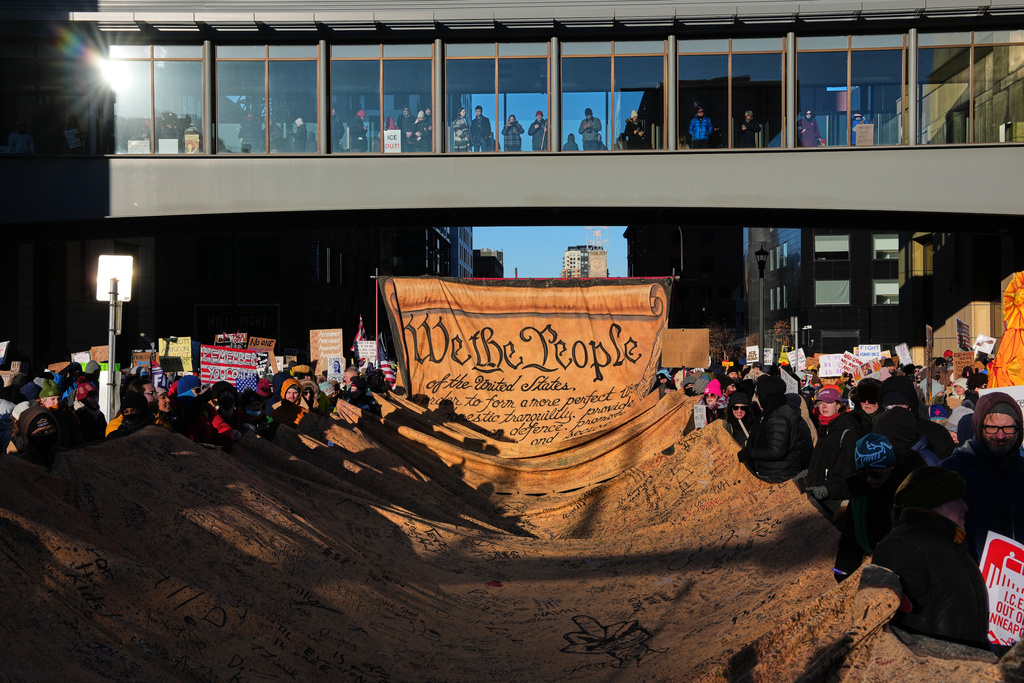 People gather during a protest Friday, Jan. 30, 2026, in Minneapolis. (AP Photo/Adam Gray)