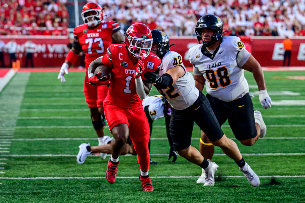 Utah running back Wayshawn Parker (1) runs out of a tackle attempt by Idaho linebacker Ryder Bordner (42) for a touchdown during an NCAA college football game Thursday, Sept. 3, 2026, in Salt Lake City. (AP Photo/Tyler Tate)