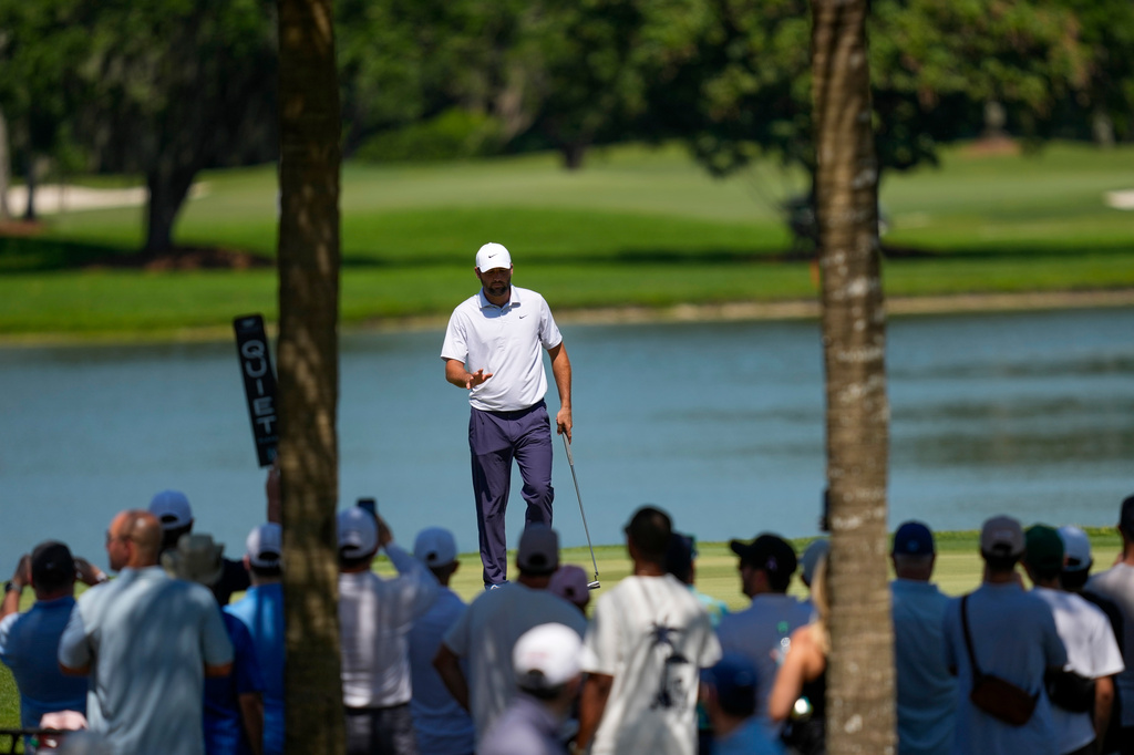 Scottie Scheffler waves after his shot on the seventh green during the second round of the Cadillac Championship PGA golf tournament Friday, May 1, 2026, in Doral, Fla. (AP Photo/David J. Phillip)