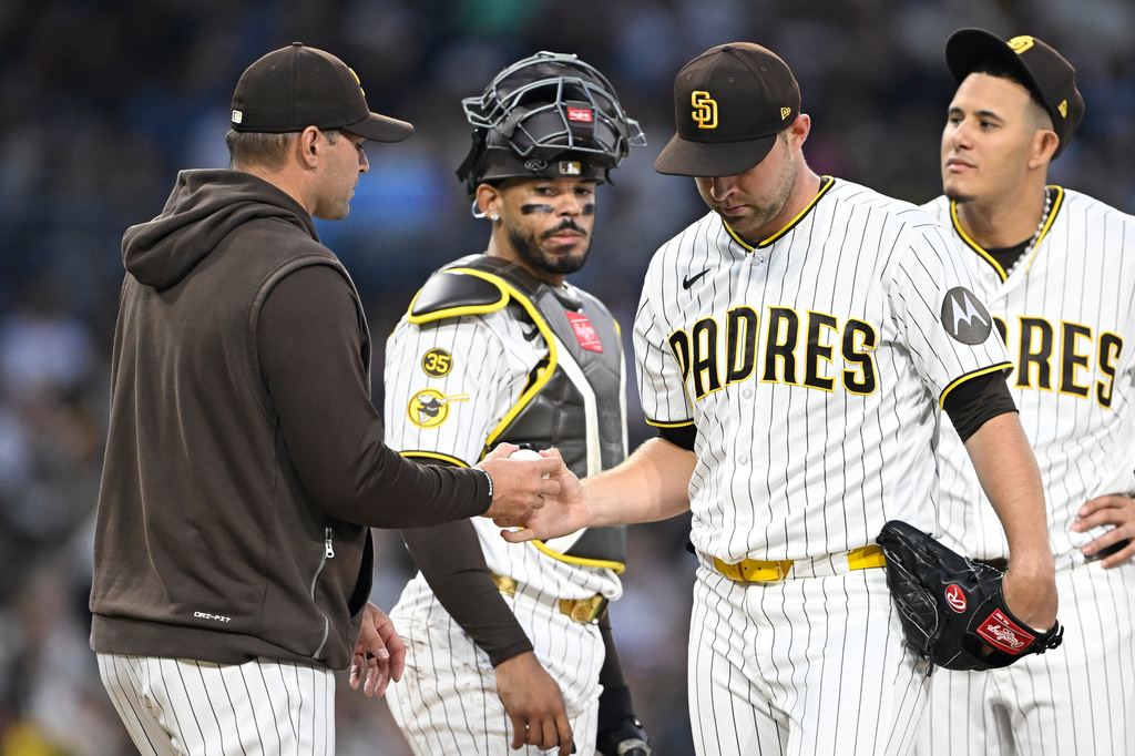 San Diego Padres pitcher Michael King hands the ball to manager Craig Stammen as he leaves the game during the seventh inning of a baseball game Saturday, May 2, 2026, in San Diego. (AP Photo/Denis Poroy)