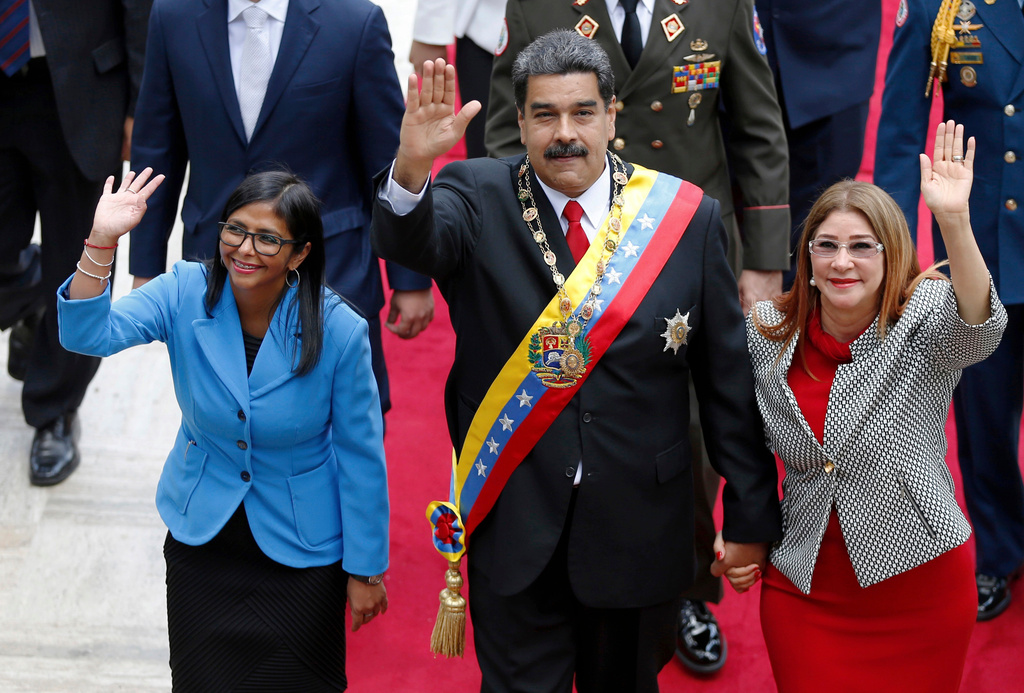 FILE - Venezuela's President Nicolas Maduro, then Constituent National Assembly President Delcy Rodriguez, left, and first lady Cilia Flores, wave as they arrive to the National Assembly, in Caracas, Venezuela, May 24, 2018. (AP Photo/Ariana Cubillos, File)