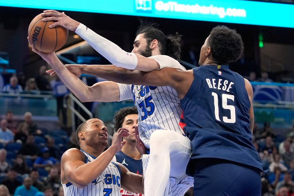 Orlando Magic center Goga Bitadze (35) grabs a rebound in front of Washington Wizards center Julian Reese (15) during the first half of an NBA basketball game, Tuesday, March 3, 2026, in Orlando, Fla. (AP Photo/John Raoux)