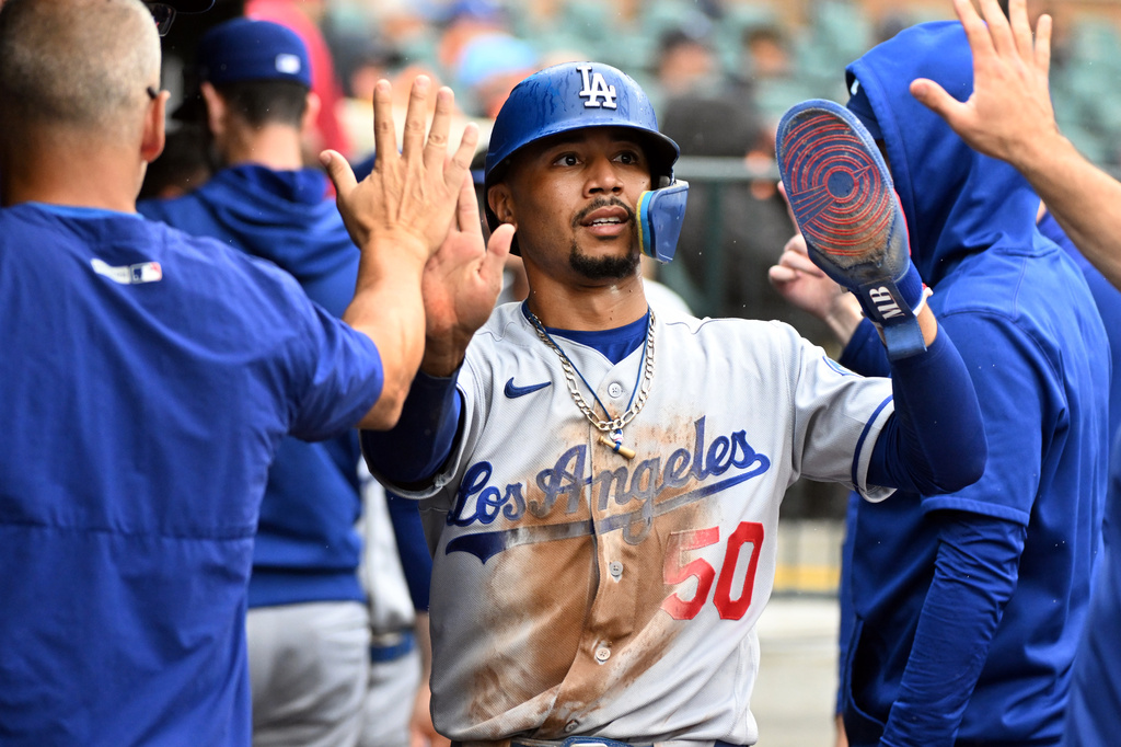 Los Angeles Dodgers' Mookie Betts (50) is congratulated in the dugout after scoring a run during the eighth inning of a baseball game against the Detroit Tigers, Sunday, Aug. 30, 2026, in Detroit. (AP Photo/Jose Juarez)
