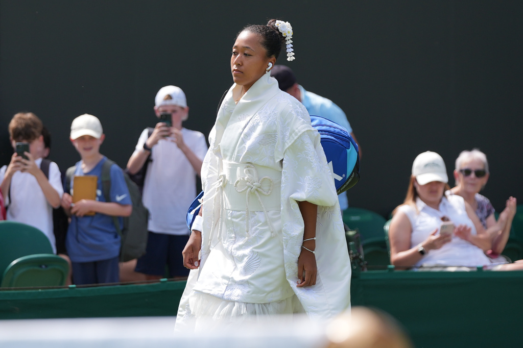 Naomi Osaka of Japan walks into the court to play against Elsa Jacquemot of France in their first round women's singles match at the Wimbledon Tennis Championships in London, Monday, June 29, 2026. (AP Photo/Maja Smiejkowska)