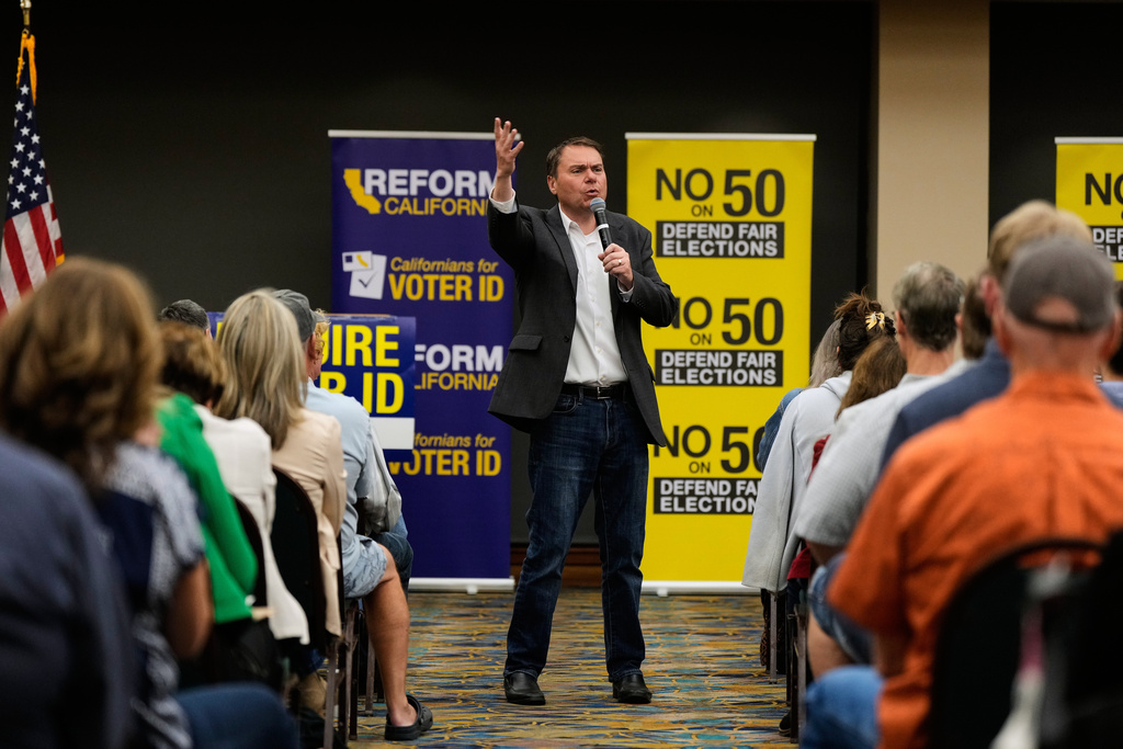 Republican Assembly member Carl DeMaio, center, speaks to people attending a No on Prop 50 rally in Redding, Calif., Tuesday, Oct. 21, 2025. (AP Photo/Godofredo A. Vásquez)