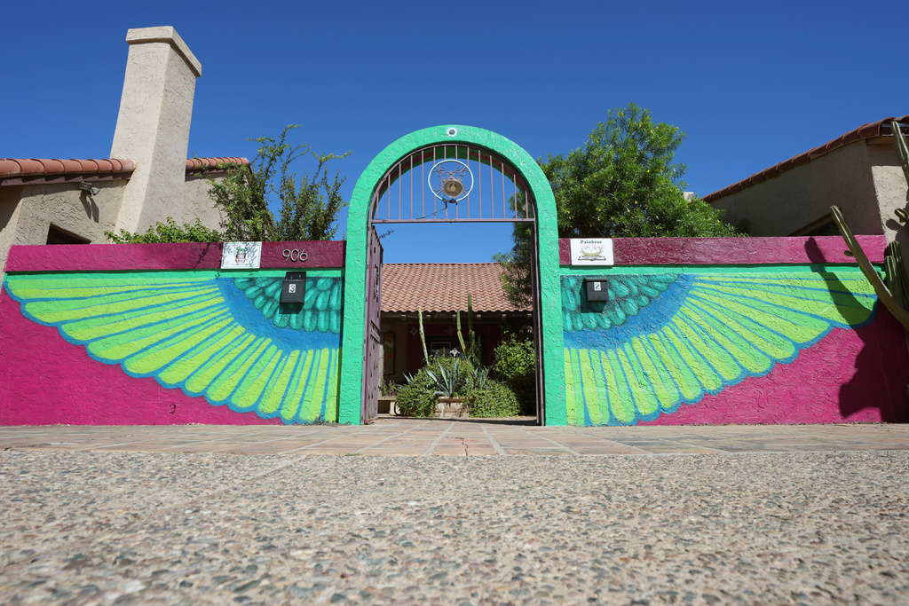 The main entrance of Palabras Bilingual Bookstore shows off colorful artwork, a theme throughout the bookstore, Monday, Oct. 6, 2025, in Phoenix. (AP Photo/Ross D. Franklin)