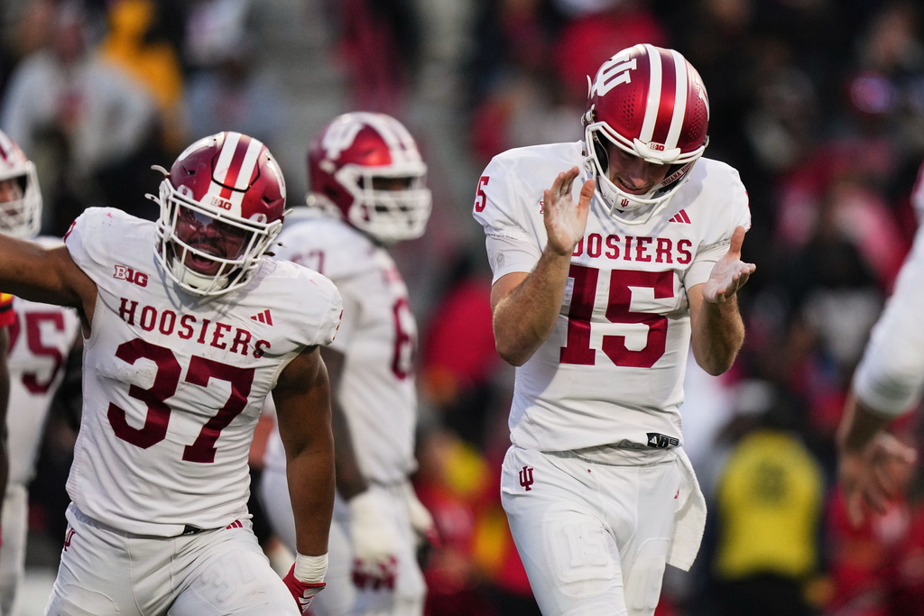 Indiana quarterback Fernando Mendoza (15) reacts after running back Roman Hemby scored a touchdown during the second half of an NCAA college football game against Maryland, Saturday, Nov. 1, 2025, in College Park, Md. (AP Photo/Stephanie Scarbrough)