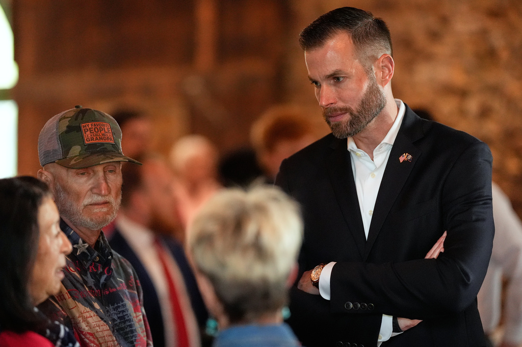 Republican candidate Clay Fuller, right, speaks to supporters during an election night watch party, Tuesday, April 7, 2026, in Ringgold, Ga. (AP Photo/Mike Stewart)