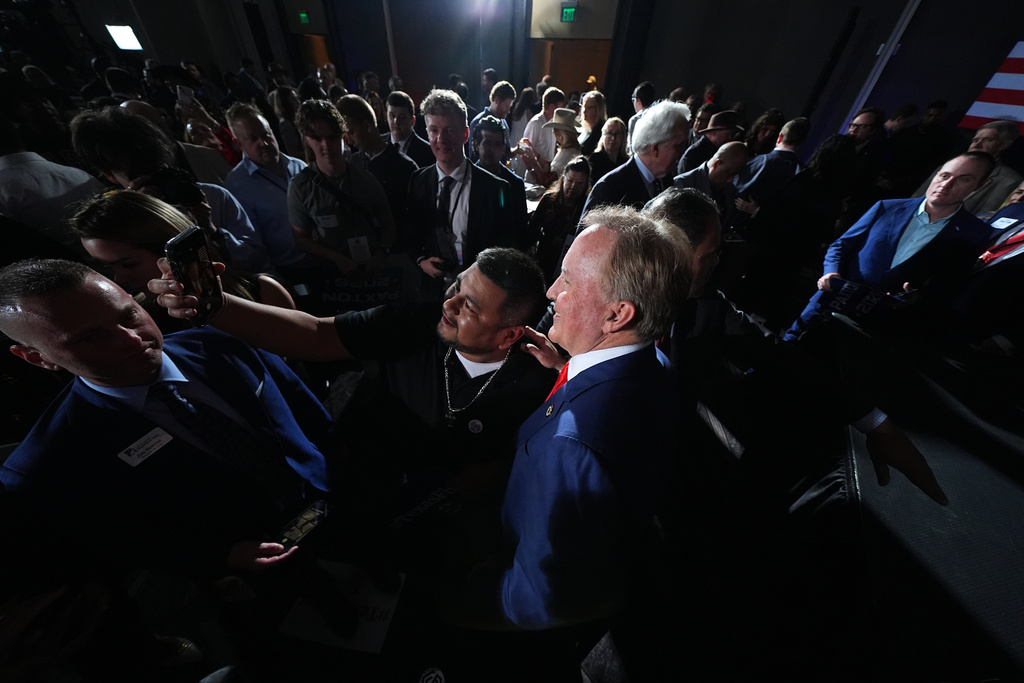 Texas Attorney General Ken Paxton, a Republican candidate for the U.S. Senate, poses for a selfie with a supporter during a primary election night watch party Tuesday, March 3, 2026, in Dallas. (AP Photo/Julio Cortez)