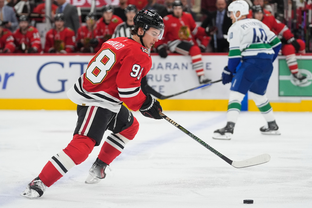 Chicago Blackhawks center Connor Bedard (98) handles the puck during the first period of an NHL hockey game against the Vancouver Canucks, Friday, Oct. 17, 2025, in Chicago. (AP Photo/Erin Hooley)