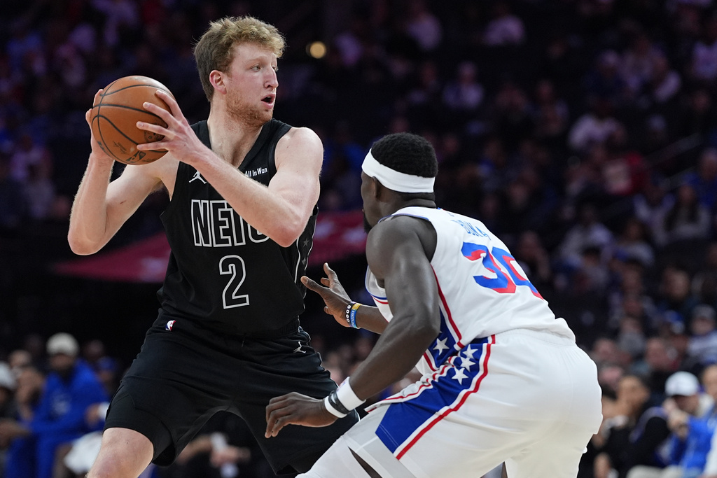 Brooklyn Nets' Danny Wolf (2) tries to get past Philadelphia 76ers' Adem Bona during the first half of an NBA basketball game Saturday, March 14, 2026, in Philadelphia. (AP Photo/Matt Rourke)