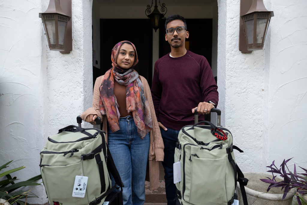 Samiha Matin, left, and Faisal Rashid pose for a portrait with their baggage for the annual Hajj pilgrimage in Mecca, Saudi Arabia, at their home in Pasadena, Calif, Sunday, May 17, 2026. (AP Photo/Ryan Sun)