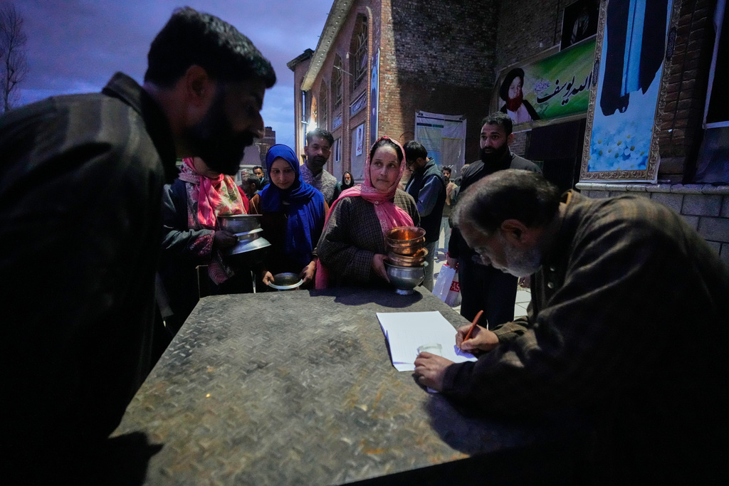 Shiite Muslim women wait to donate copper kitchenware during a relief drive for Iran in Budgam, Indian-controlled Kashmir, Monday, March 23, 2026. (AP Photo/Mukhtar Khan)