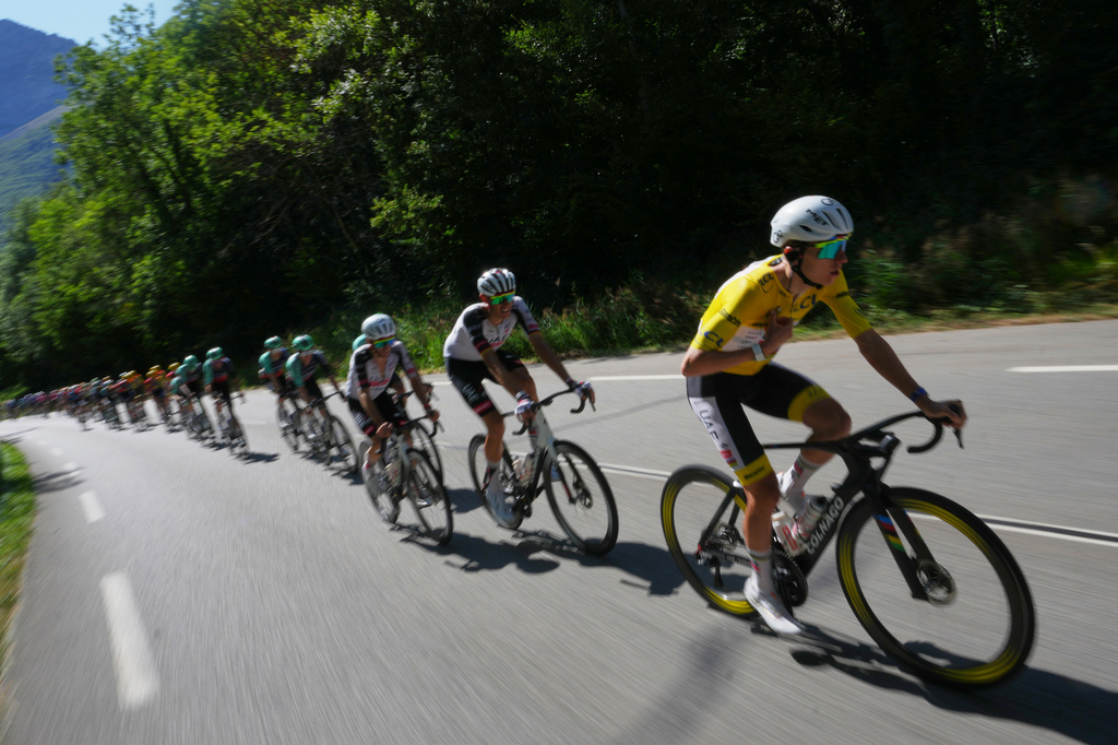 Slovenia's Tadej Pogacar, wearing the overall leader's yellow jersey, rides in the pack during the eighteenth stage of the Tour de France cycling race, with start in Voiron and finish in Orcieres-Merlette, France, Thursday, July 23, 2026. (AP Photo/Thibault Camus)