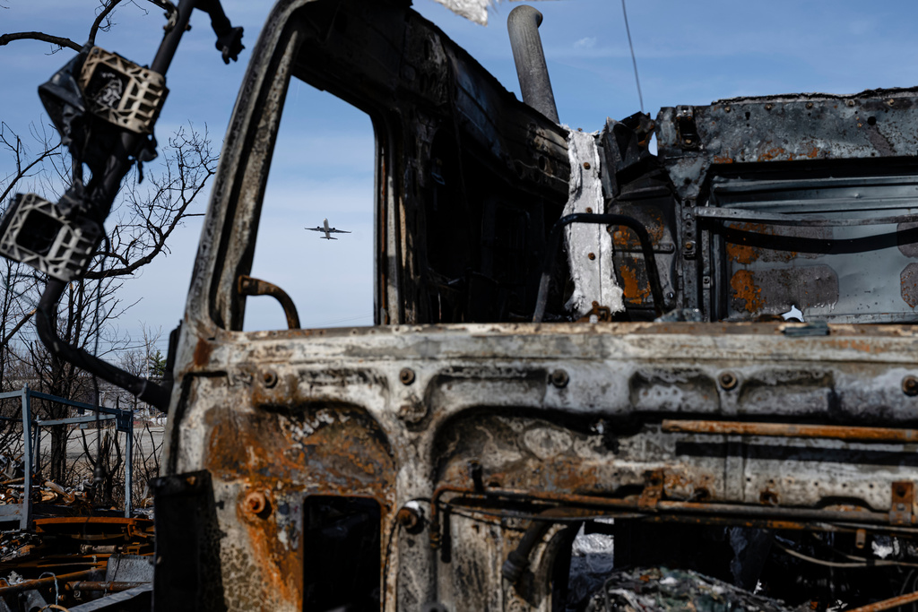A UPS Boeing 737 takes over a destroyed truck during a tour of the UPS plane crash site, Tuesday, Jan. 13, 2026, in Louisville, Ky. (AP Photo/Jon Cherry)