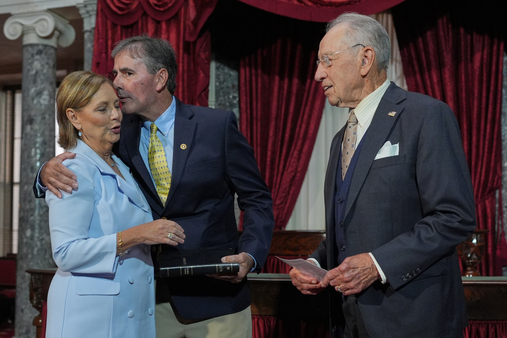 Sen. Darline Graham, R-S.C., sister of Sen. Lindsey Graham, R-S.C., is ceremonially sworn-in by President Pro Tempore of the Senate, Chuck Grassley, R-Iowa, in the Old Senate Chamber at the Capitol in Washington, Tuesday, July 14, 2026, as her husband Larry Nordone holds the Bible and gives her a kiss. (AP Photo/J. Scott Applewhite)