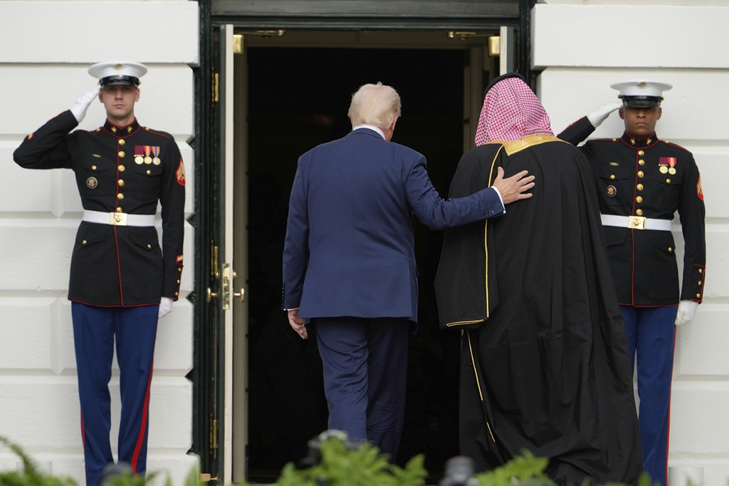 President Donald Trump escorts Saudi Arabia's Crown Prince Mohammed bin Salman into the White House, Tuesday, Nov. 18, 2025, in Washington. (AP Photo/Mark Schiefelbein)