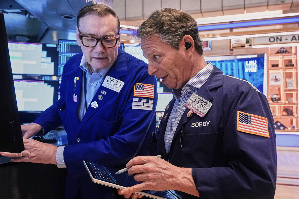 Specialist Patrick King, left, and trader Robert Charmak work on the floor of the New York Stock Exchange, Thursday, Feb. 19, 2026. (AP Photo/Richard Drew)