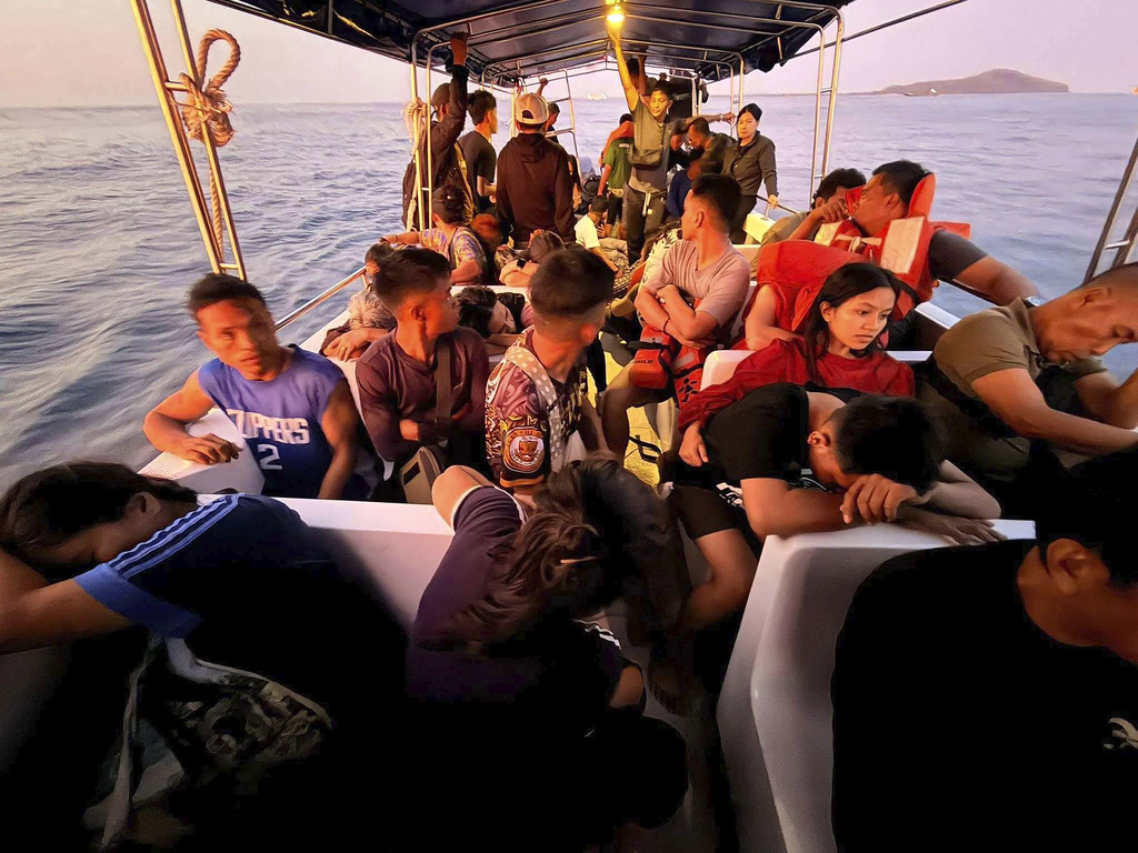 Rescued passengers from M/V Trisha Kerstin, 3 an inter-island cargo and passenger ferry that sank, on a boat around waters of Isabela City, Basilan Province, Philippines on Monday, Jan. 26, 2026. (Kagawad Gamar "Gams" Alih via AP)