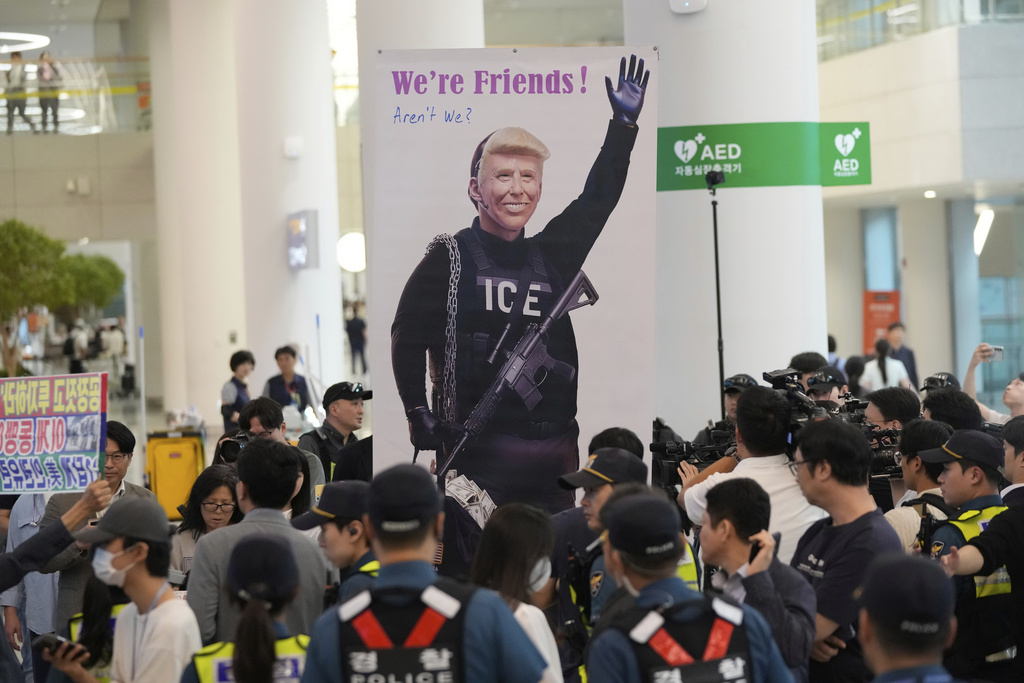 A banner depicting U.S. President Donald Trump is seen at the arrival terminal of the Incheon International Airport, in Incheon, South Korea, Friday, Sept. 12, 2025. (AP Photo/Ahn Young-joon)