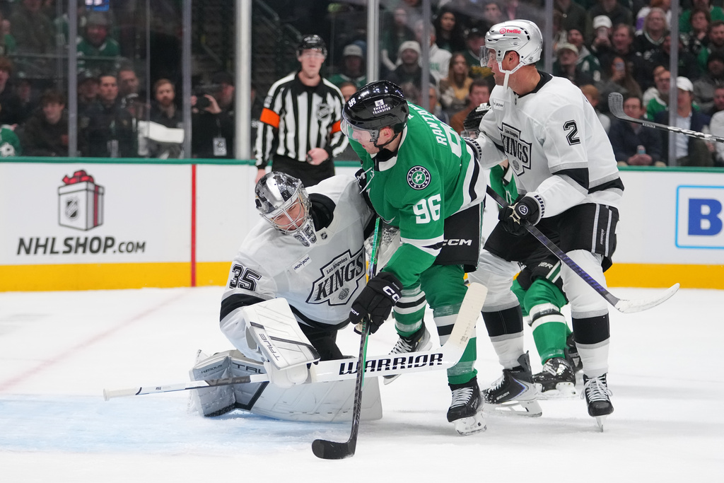 Los Angeles Kings goaltender Darcy Kuemper, left, collides with Dallas Stars right wing Mikko Rantanen during the first period of an NHL hockey game Monday, Dec. 15, 2025, in Dallas. (AP Photo/Julio Cortez)