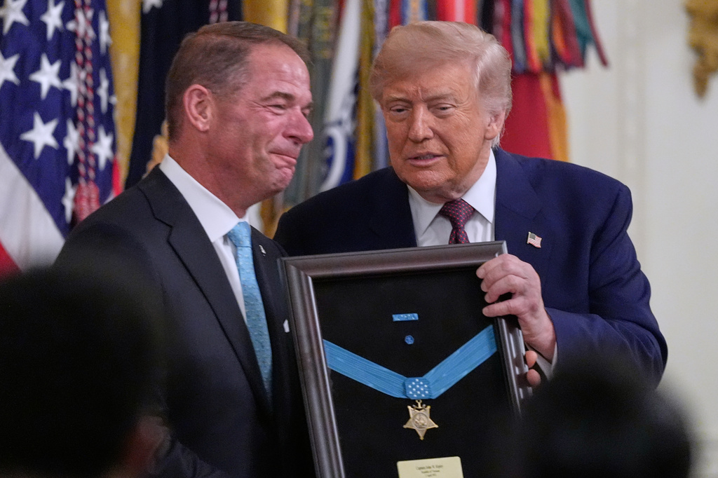 President Donald Trump stands with Tom Ripley, son of U.S. Marine Corps Col. John W. Ripley, as he posthumously presents the Medal of Honor during an East Room ceremony at the White House in Washington, Thursday, June 18, 2026 in Washington. (AP Photo/Manuel Balce Ceneta)