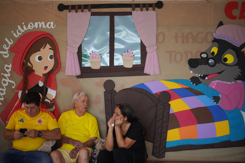 People sit waiting for their turn to vote at a school serving as a polling station during the runoff election in Barranquilla, Colombia, Sunday, June 21, 2026. (AP Photo/Ivan Valencia)