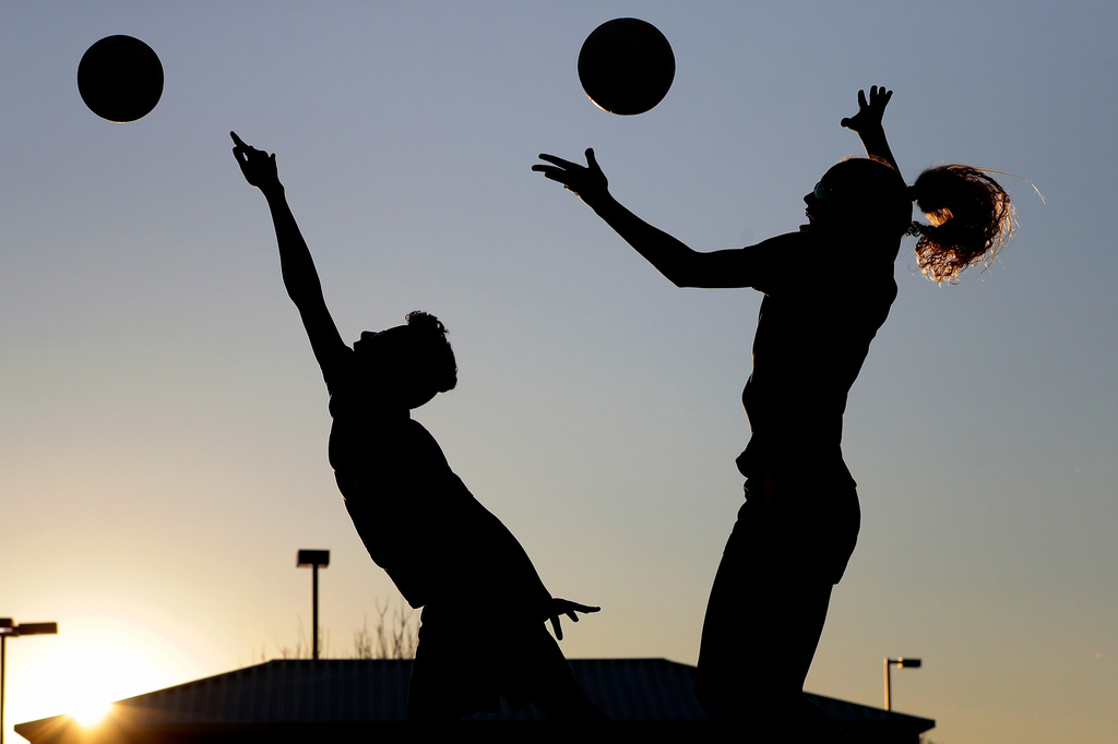 FILE - Friends practice volleyball at a local park in Gilbert, Ariz., March 15, 2020. (AP Photo/Matt York, File)