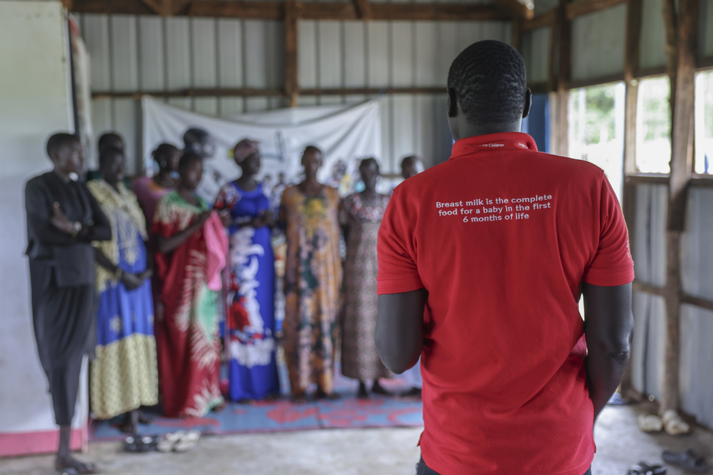 An aid worker speaks to mothers eligible for nutrition support in an camp for internally displaced people in Bor, South Sudan, Aug 18, 2025. (AP Photo/Caitlin Kelly)