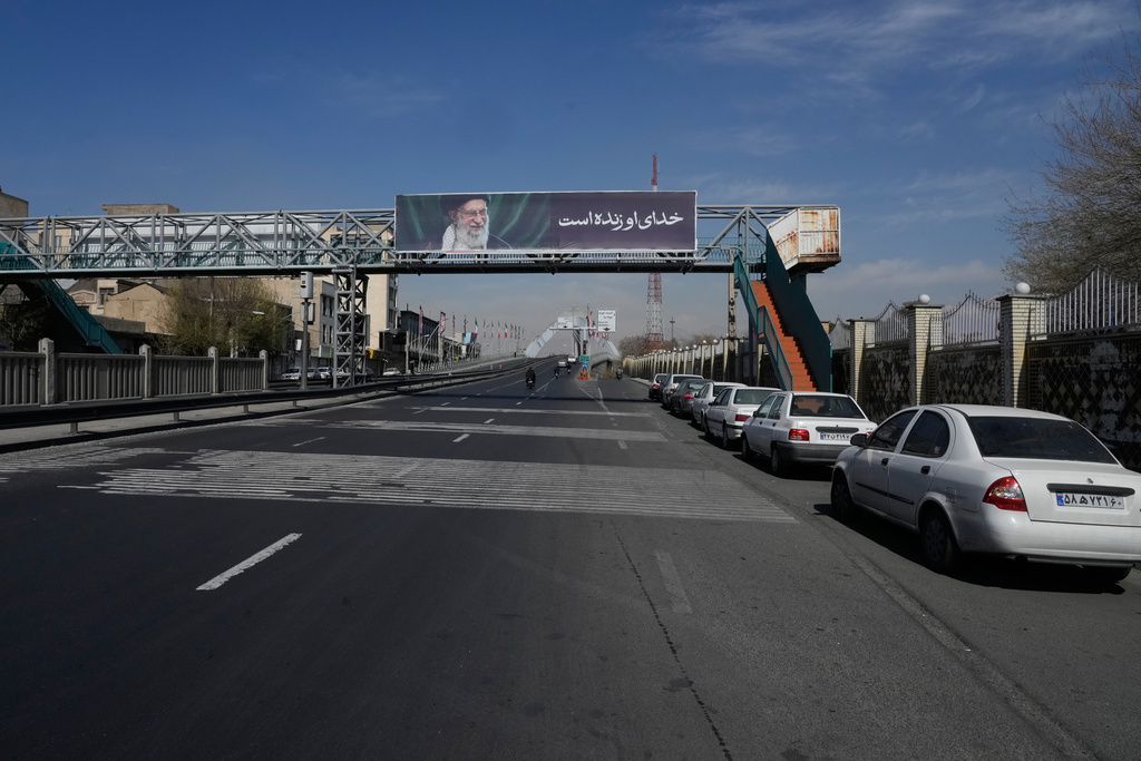 A billboard shows a portrait of the late Iranian Supreme Leader Ayatollah Ali Khamenei, who was killed during ongoing joint U.S.-Israeli military strikes, and the words in Farsi: "His God is alive," in Tehran, Iran, Thursday, March 5, 2026. (AP Photo/Vahid Salemi)