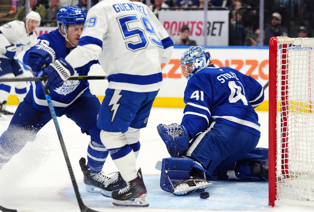 Toronto Maple Leafs' goaltender Anthony Stolarz (41) makes a save as teammate Jake McCabe (22) and Tampa Bay Lightning's Jake Guentzel (59) battle during the first period of an NHL hockey game in Toronto, Saturday, March 7, 2026. (Frank Gunn/The Canadian Press via AP)