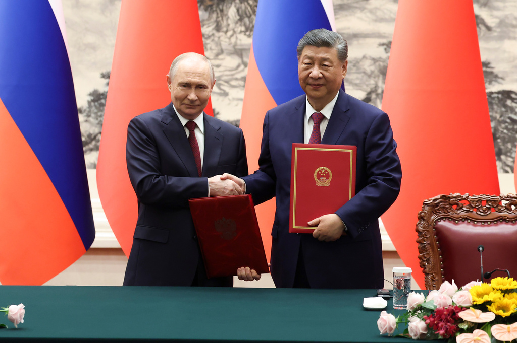 FILE - Russian President Vladimir Putin, left, and Chinese President Xi Jinping shake hands during a signing ceremony at the Great Hall of the People in Beijing, May 20, 2026. (Maxim Shemetov/Pool Photo via AP, File)