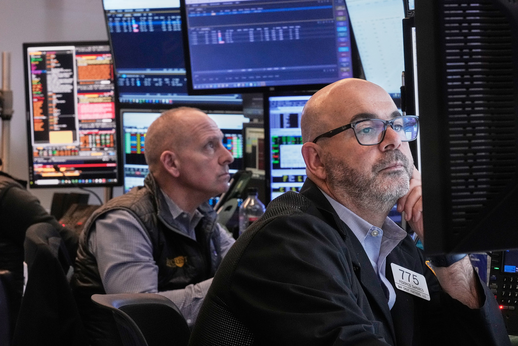 Traders Michael Urkonis, left, and Fred Demarco work on the floor of the New York Stock Exchange, Tuesday, Dec. 2, 2025. (AP Photo/Richard Drew)