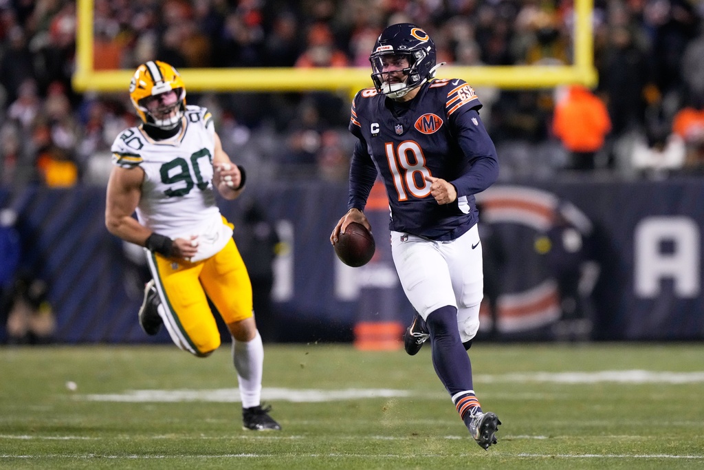 Chicago Bears' Caleb Williams gets away from Green Bay Packers' Lukas van Ness during the second half of an NFL football game Saturday, Dec. 20, 2025, in Chicago. (AP Photo/Nam Huh)