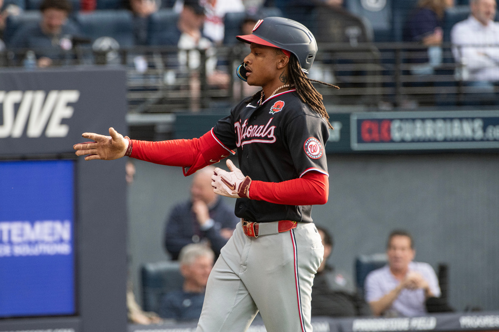 Washington Nationals' CJ Abrams reaches for a teammate after hitting a solo home run off Cleveland Guardians starting pitcher Tanner Bibee during the third inning of a baseball game, Monday, May 25, 2026, in Cleveland. (AP Photo/Phil Long)