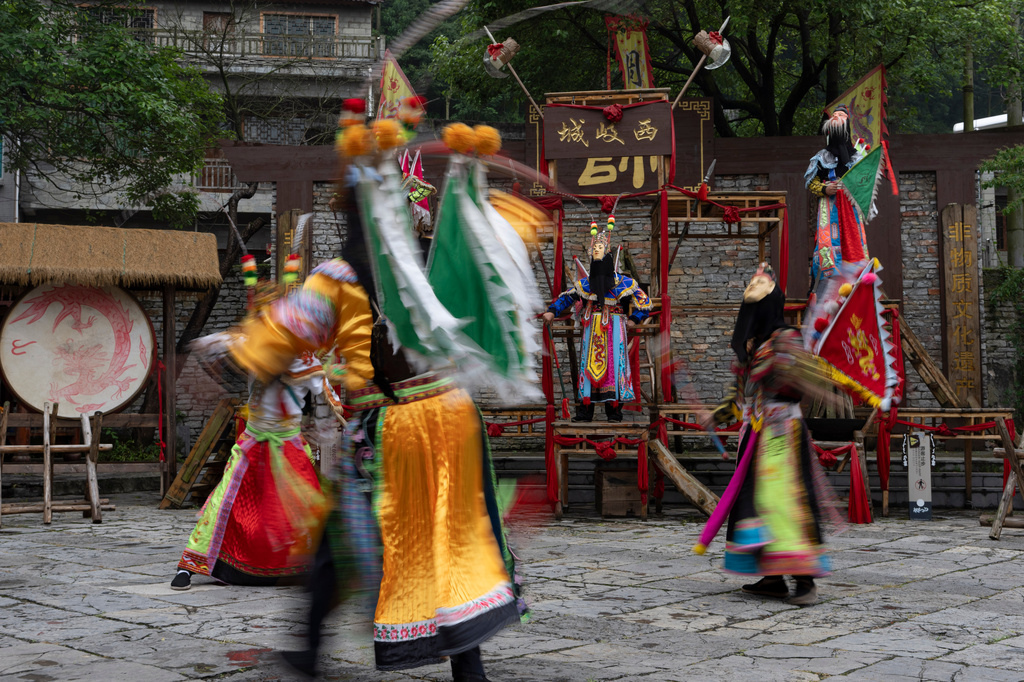 Performers take part in a Dixi opera show at Tianlong Tunpu, an ancient town in southwestern China's Guizhou province, on Thursday, May 28, 2026. (AP Photo/Ng Han Guan)