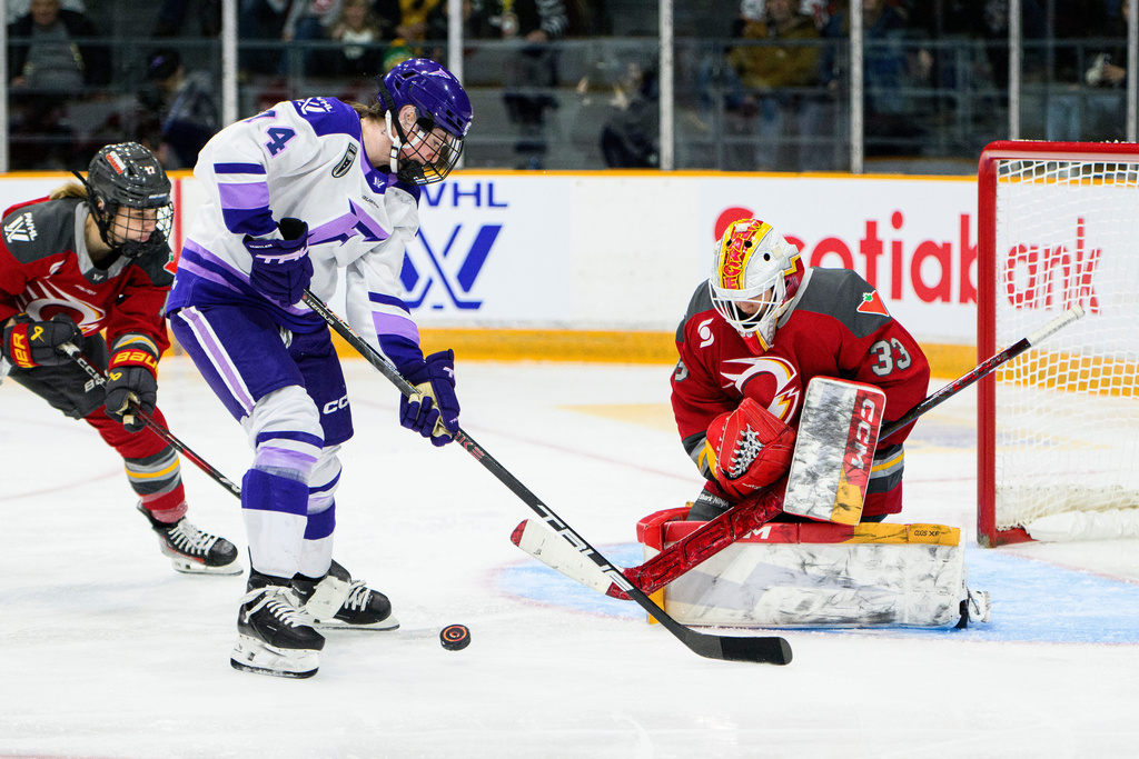 Minnesota Frost's Abby Hustler (74) looks for a rebound in front of Ottawa Charge goaltender Gwyneth Philips (33) during second period PWHL hockey action in Ottawa, on Saturday, Jan. 3, 2026. (Spencer Colby/The Canadian Press via AP)