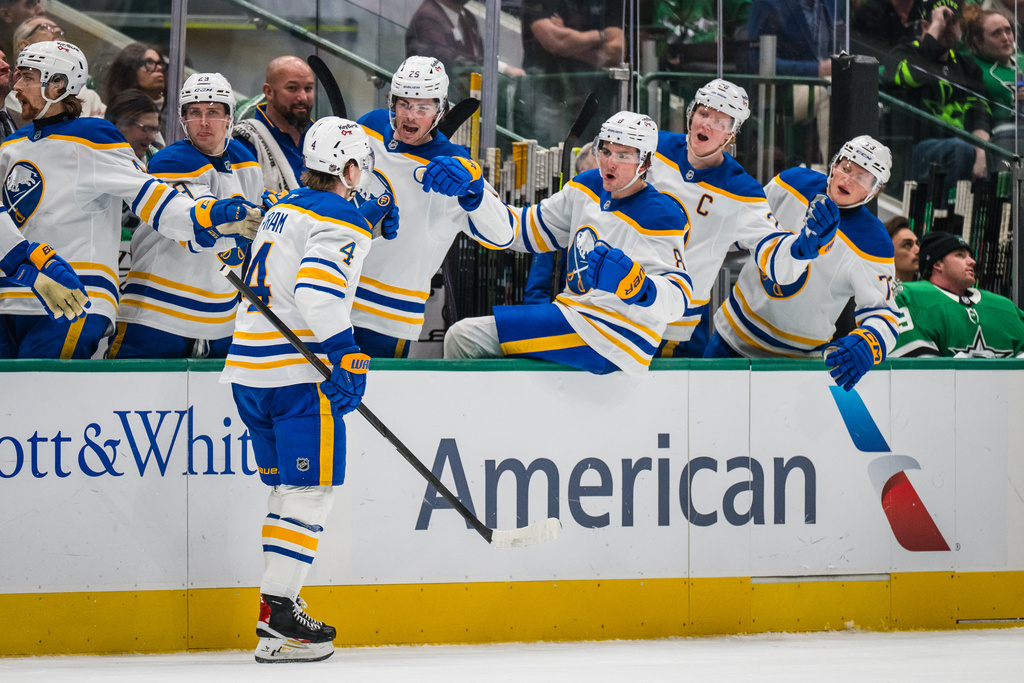 Buffalo Sabres defenseman Bowen Byram (4) celebrates a goal with the bench during an NHL hockey game against the Dallas Stars, Wednesday, Dec. 31, 2025, Dallas. (AP Photo/Jessica Tobias)