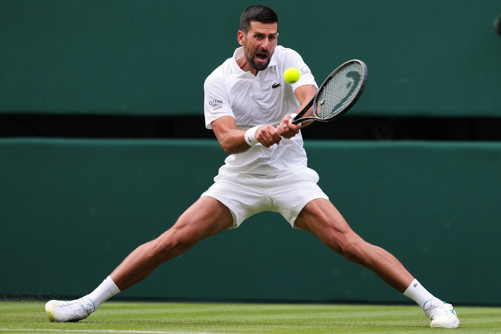 Novak Djokovic of Serbia plays a return to Yibing Wu of China during the men's singles at the Wimbledon Tennis Championships in London, Monday, June 29, 2026.(AP Photo/Kin Cheung)