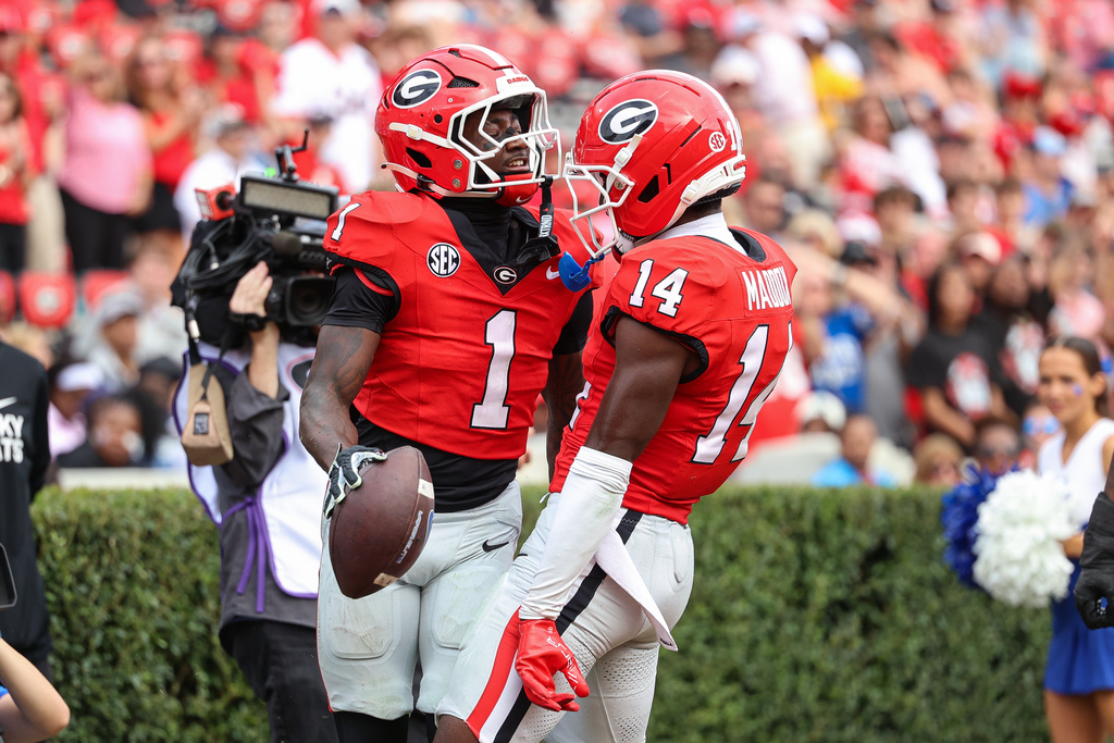 Georgia defensive back Ellis Robinson IV (1) reacts with defensive back Adrian Maddox (14) after intercepting a pass during the second half of an NCAA college football game against Kentucky, Saturday, Oct. 4, 2025, in Athens, Ga. (AP Photo/Colin Hubbard)