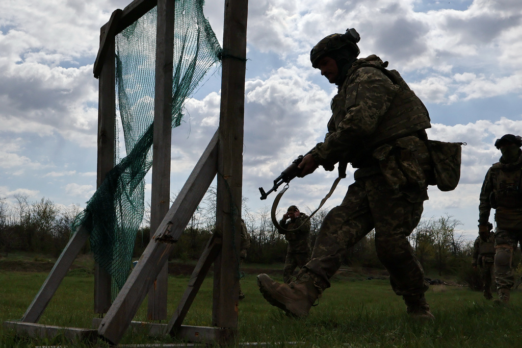 In this photo provided by Ukraine's 65th Mechanized Brigade press service, recruits practice military skills at a training ground near the frontline in the Zaporizhzhia region, Ukraine, Wednesday, April 29, 2026. (Andriy Andriyenko/Ukraine's 65th Mechanized Brigade via AP)