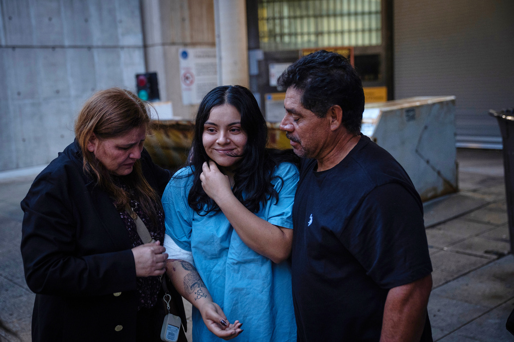Marimar Martinez, center, is greeted by her family after being released from the Metropolitan Correctional Center on Oct. 6, 2025, after being shot by immigration agents and charged with assaulting federal officers in an incident in Chicago's Brighton Park. (E. Jason Wambsgans/Chicago Tribune via AP)